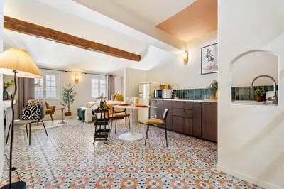 a kitchen and living room with a table and chairs at Nice Renting - CENTRALE - Authentic Loft Old Nice Rooftop View & Charm in Nice