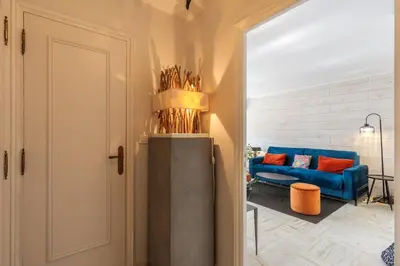 a living room with a blue couch and a blue chair at Jolie studio avec belle terrasse ensoleillee in Nice