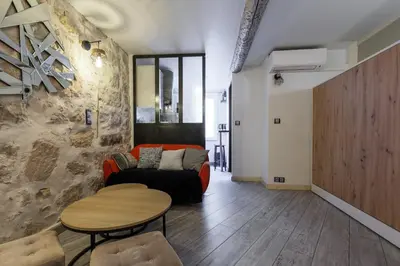 a living room with a couch and a table at Coquet studio place du pin in Nice