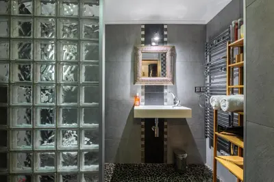a bathroom with a sink and a glass wall at Coquet studio place du pin in Nice