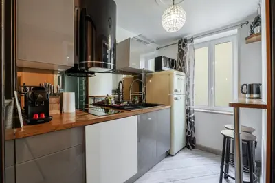 a kitchen with a sink and a refrigerator at Coquet studio place du pin in Nice