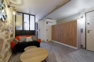 a living room with a couch and a table at Coquet studio place du pin in Nice