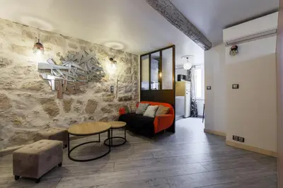 a living room with a couch and a table at Coquet studio place du pin in Nice