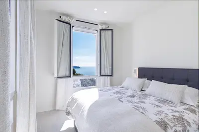 a bedroom with a bed and a large window at New - sea view - splendid apartment in Nice