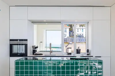 a kitchen with a green tile counter and a window at New - sea view - splendid apartment in Nice