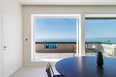 a dining room with a table and a view of the ocean at New - sea view - splendid apartment in Nice