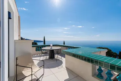 a balcony with a table and chairs and the ocean at New - sea view - splendid apartment in Nice