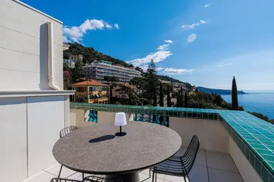 a table on a balcony with a view of the ocean at New - sea view - splendid apartment in Nice