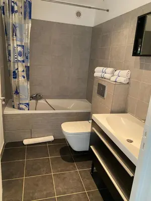 a bathroom with a tub and a toilet and a sink at STUDIO SUPER AQUARAMA Bord de mer in Saint-Laurent-du-Var
