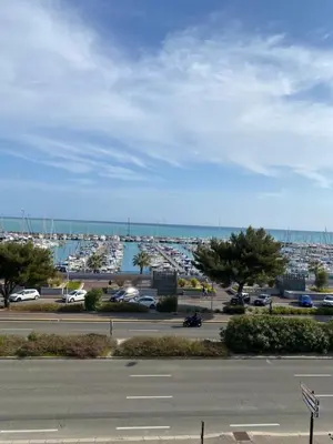 a parking lot with a view of a harbor at STUDIO SUPER AQUARAMA Bord de mer in Saint-Laurent-du-Var