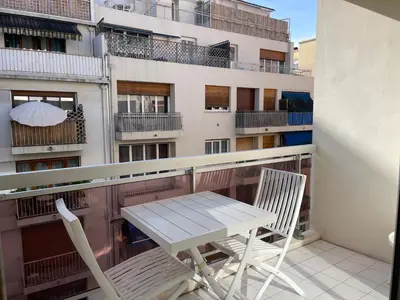 a table and chairs on a balcony with a building at apppartement avec terrasse - 2 à 4 personnes in Nice