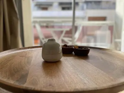 a wooden table with two bowls of food on it at apppartement avec terrasse - 2 à 4 personnes in Nice