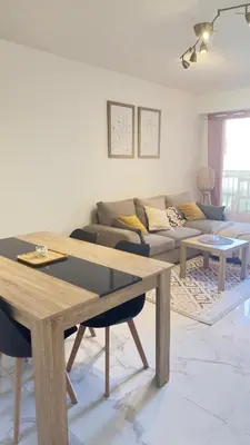 a living room with a table and a couch at Grand 2 pièces avec grande terrasse à 15mn Centre-ville, Gare et Promenade des Anglais in Nice