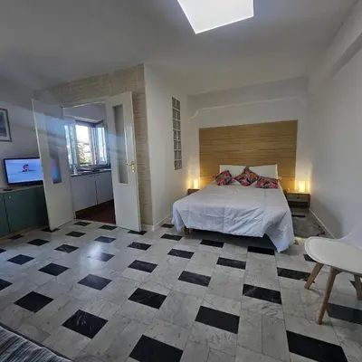 a bedroom with a bed and a checkered floor at Vue mer studio tout équipé in Nice