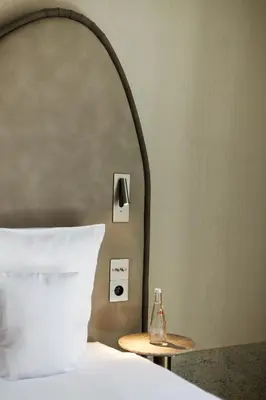 a bedroom with a bed with a mirror and a bottle on a table at Notre Dame Hotel - Self Check-in in Nice