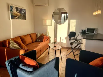 a living room with a couch and two chairs at Appartement Eze Village proche Monaco fabuleuse vue mer et vieux village in Èze