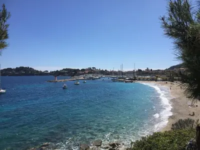 a view of a beach with boats in the water at Appartement Eze Village proche Monaco fabuleuse vue mer et vieux village in Èze