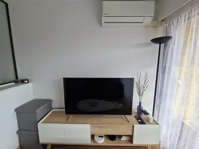 a living room with a tv on top of a table at Chez Stella - Proche Mer in Nice