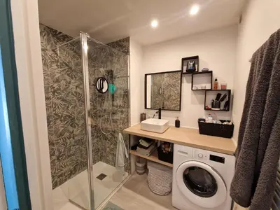a bathroom with a shower and a washing machine at Chez Stella - Proche Mer in Nice