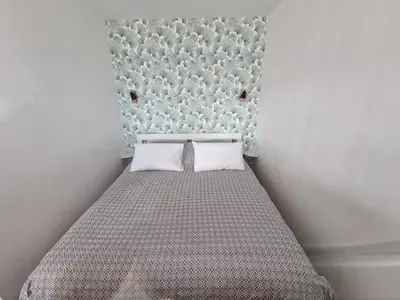 a small bedroom with a bed with two pillows at Chez Stella - Proche Mer in Nice