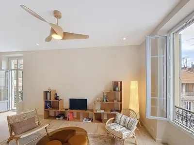 a living room with a ceiling fan and a tv at Nestor&Jeeves - PEPYTE - Design - Near Beach in Nice
