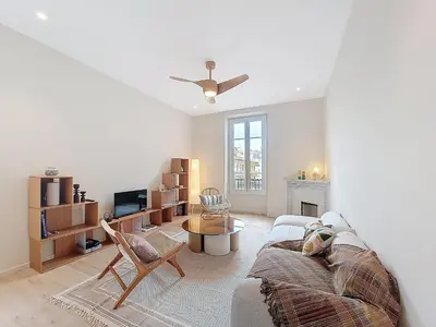 a living room with a couch and a tv at Nestor&Jeeves - PEPYTE - Design - Near Beach in Nice