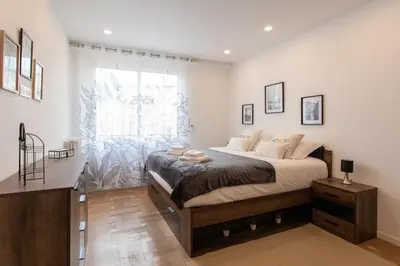 a bedroom with a large bed and a window at L38 Hobeika Suite Fleur 7min Walk To Beach,Free Park,Balc&AC in Nice