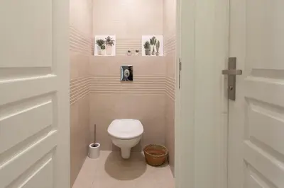a small bathroom with a toilet in a room at L38 Hobeika Suite Fleur 7min Walk To Beach,Free Park,Balc&AC in Nice