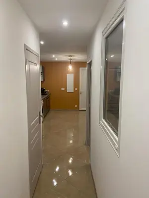 an empty hallway with a door and a window at Appartement T3 dans une villa au calme in Drap