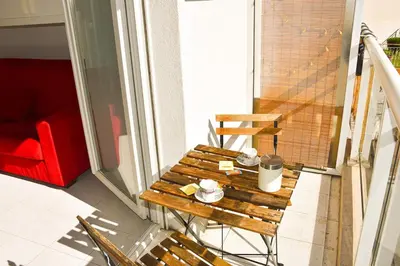 a wooden bench sitting on top of a balcony at Studio avec terrasse à Nice in Nice