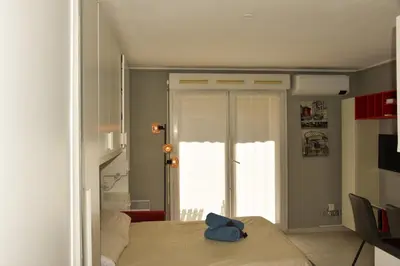 a bedroom with a bed with a blue bag on it at Studio avec terrasse à Nice in Nice