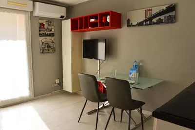 a dining room with a glass table and chairs at Studio avec terrasse à Nice in Nice