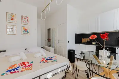a bedroom with a bed and a table and chairs at Modern 3BR Duplex Near Nice Port & Old Town | By Airnest in Nice
