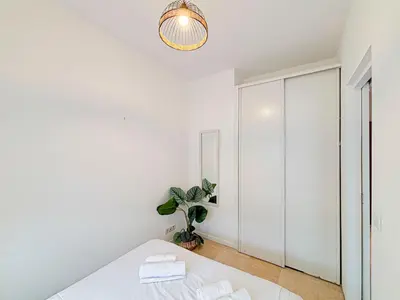 a white bedroom with a bed and a closet at Plage, Promenade & confort - Wifi, AC, 4 pers in Nice