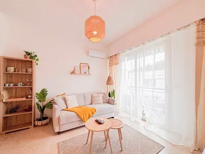 a living room with a couch and a table at Plage, Promenade & confort - Wifi, AC, 4 pers in Nice