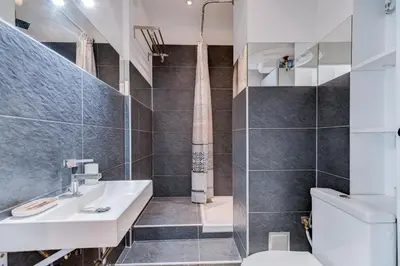 a bathroom with a sink and a toilet at Plage, Promenade & confort - Wifi, AC, 4 pers in Nice