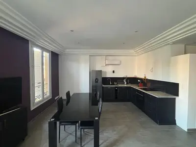 a large kitchen with a table and a refrigerator at 3-R bright, beach within 15 min walk in Nice