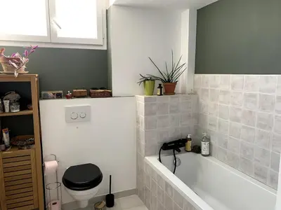 a bathroom with a toilet and a bath tub at 3-R bright, beach within 15 min walk in Nice