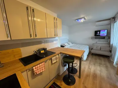 a kitchen with a sink and a bed in a room at Beau Studio avec belle terrasse au centre ville de Nice in Nice