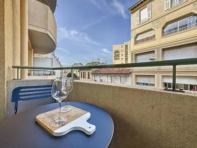 a table with a wine glass on a balcony at Studio calme avec balcon proche du port de Nice in Nice