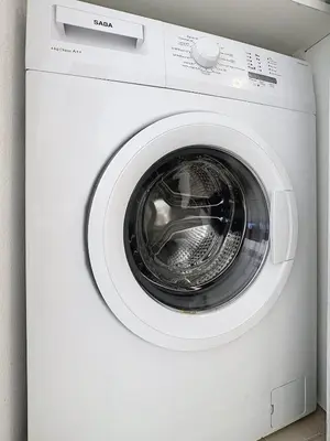a white washing machine sitting in a room at Studio calme avec balcon proche du port de Nice in Nice