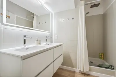 a white bathroom with a sink and a shower at Nice Renting - FLEURS - Luxury Stay Terrace Quiet Private Parking in Nice