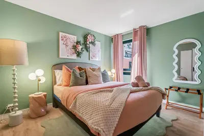 a bedroom with a bed with pink and green walls at Nice Renting - FLEURS - Luxury Stay Terrace Quiet Private Parking in Nice