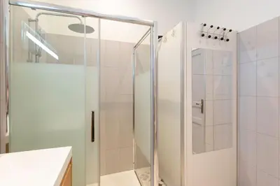 a shower with a glass door in a bathroom at #34 Lamartine Central 3 Bdrs AC balcony 10mins walk to old town in Nice