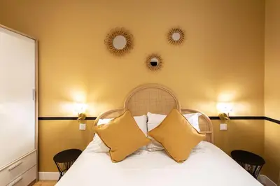 a bedroom with a bed with two mirrors on the wall at #34 Lamartine Central 3 Bdrs AC balcony 10mins walk to old town in Nice