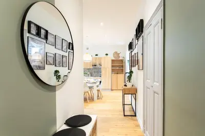 a hallway with a mirror and a dining room at #34 Lamartine Central 3 Bdrs AC balcony 10mins walk to old town in Nice