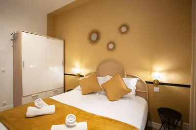 a bedroom with a bed and two mirrors on the wall at #34 Lamartine Central 3 Bdrs AC balcony 10mins walk to old town in Nice