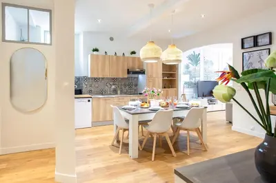 a kitchen and dining room with a table and chairs at #34 Lamartine Central 3 Bdrs AC balcony 10mins walk to old town in Nice
