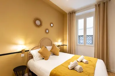 a bedroom with a large bed with towels on it at #34 Lamartine Central 3 Bdrs AC balcony 10mins walk to old town in Nice