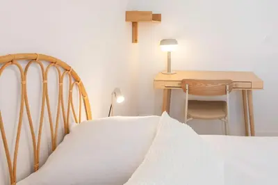 a bedroom with a bed and a desk with a cross at #35 Suite Carlone 5min from the beach AC & Terrace in Nice